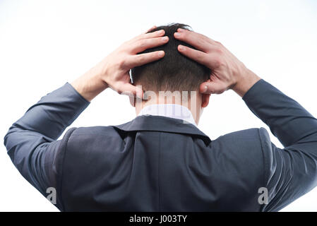 Stress Geschäftsansicht Mann von hinten hielt seinen Kopf Stockfoto