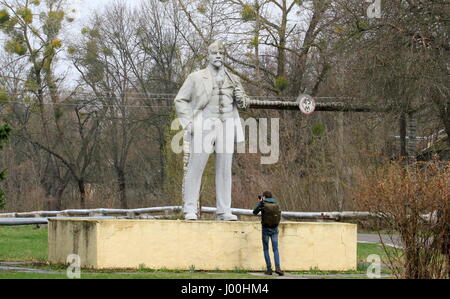 Tschernobyl, Ukraine. 5. April 2017. Ein Mann fotografiert eine Lenin-Statue in Tschernobyl, Ukraine, am 5. April 2017. Die ukrainische Regierung hat vor kurzem das Gebiet rund um Atomkraftwerk Tschernobyl als Biosphärenreservat erklärt, weil Tiere in der verlassenen Gegend ohne menschliche Präsenz floriert. Bildnachweis: Chen Junfeng/Xinhua/Alamy Live-Nachrichten Stockfoto