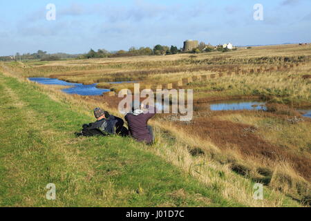 Zwei Personen-Vogelbeobachtung in küstennahen Sumpfgebieten nahe Shingle Street, Suffolk, England Stockfoto