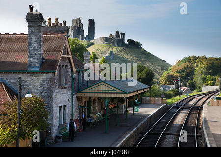 Corffe Burg-Bahnhof und die Ruinen des Schlosses in der Ferne während späten Nachmittag Sommersonnenschein Stockfoto