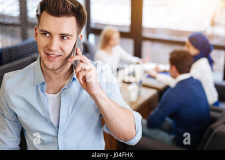 Posityive Mann reden über Handy Stockfoto