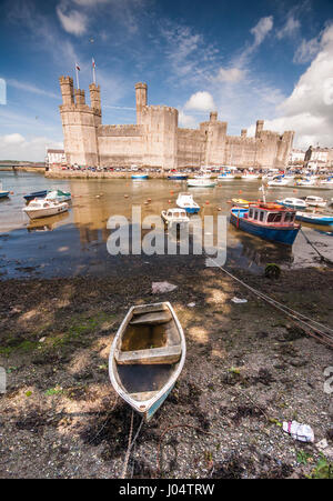 Caernarfon, Wales - 10. Mai 2011: Die mittelalterliche Burg des 13. Jahrhunderts spiegelt sich in den Fluss in Caernarfon in Nord-Wales, heute ein UNESCO-Welterbe. Stockfoto