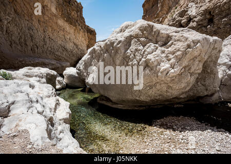 Großen Steinen am Fluss gehen durch die Schlucht des Wadi Bani Khalid, Sultanat von Oman. Dies ist einer der am meisten besuchten Ort des Landes Stockfoto