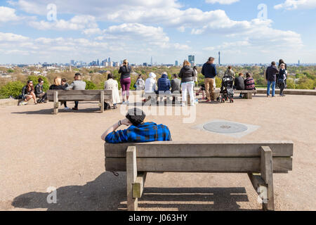 Menschen entspannend an einem sonnigen Tag im Frühling im Park, Primrose Hill und genießen Sie den Blick auf London, England, Großbritannien Stockfoto