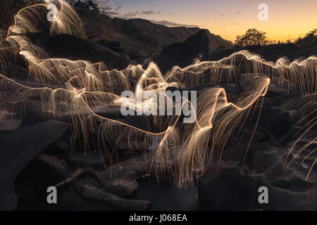 BRASILIANISCHE MITTELLAND, Brasilien: Natur und Wissenschaft haben verschmolzen, wie ein Fotograf Feuerwerk abgefeuert von Bäumen verwendet, um ihnen Licht zu bluten. Die magische Aufnahmen zeigen Bäume und einen See, beleuchtet von den Licht-Trails aus Fireworks in lagen über Brasiliens Mittelland, ein Wildlife-reiche Landschaft für die meisten der östlichen, zentralen und südlichen Teil von Brasilien. Lokalen Fotografen Vitor Schietti manuell winkte Feuerwerk mit Hilfe einer langen Stange, die wirbelnden Muster zu erstellen und bis zu zwölf Fotografien um das Finale zu erreichen, man die Sammlung von Bildern nennt, geschichteten "vergänglich Stockfoto