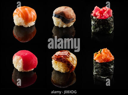 Eingestellt von Sushi Kugeln und Maki Rollen über schwarzen Hintergrund Stockfoto