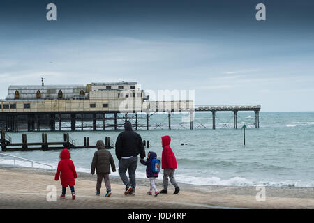 Aberystwyth Wales UK.  Mittwoch, 12. April 2017 UK Wetter: kalter, grau, windiger und bewölkter Tag in Aberystwyth, Wales, wie Familien Fuß entlang der Strandpromenade im Vorfeld bis Ostern Urlaubswochenende Foto Keith Morris / Alamy Live News Stockfoto