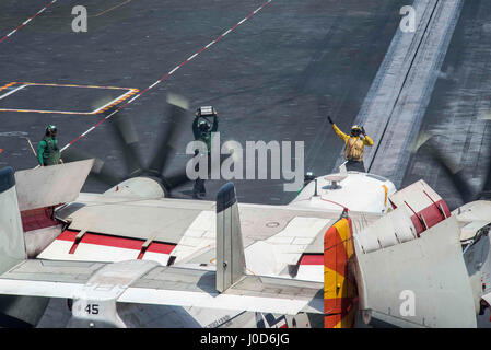 US Navy Matrosen direkt eine C-2A Greyhound-Frachtflugzeugen befestigt "Rohhäute" Fleet Logistics Support Squadron 40 auf dem Flugdeck der Flugzeugträger der Nimitz-Klasse USS George H.W. Bush 9. April 2017 in den Persischen Golf. Der Flugzeugträger ist im Betrieb innewohnende zu lösen, gegen den islamischen Staat im Irak und in Syrien eingesetzt. Stockfoto