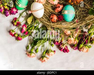 Ostern Essen: Osterkuchen, gefärbten Eiern, Glas mit Gänseleber, Süßigkeiten, hausgemachte Bratwurst, gekochtes Schweinefleisch, Ei aus weißer Schokolade am Heu gelegt Stockfoto