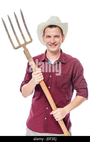 Erfolgreicher Jungbauer in ein rotes Hemd mit Mistgabeln isoliert Stockfoto