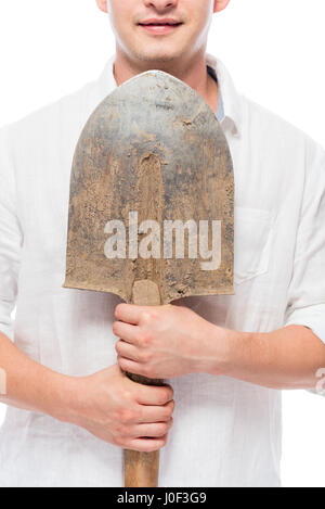 Nahaufnahme von einer Schaufel Erde in männlicher Hand gebeizt Stockfoto