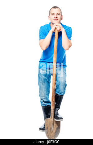 verträumte Arbeiter mit einer Schaufel auf einem weißen Hintergrund in voller Länge Stockfoto