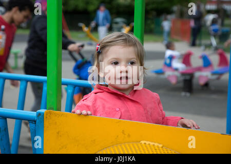 Mädchen Kleinkind 16 Monate in einen öffentlichen Park Spielplatz Stockfoto