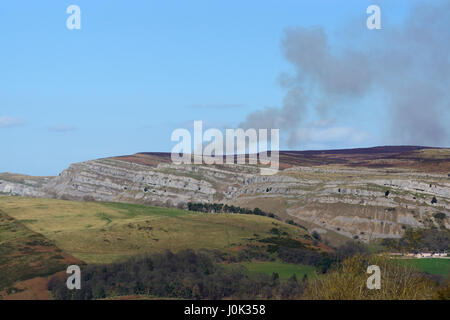 Rauch aus einem fernen Heide Feuer auf dem eglwyseg Böschung in der Nähe von Worlds End Panoroma oben Llangollen in Denbighshire Wales Stockfoto