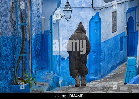 Ein Mann in typisch marokkanische Kleidung, auf einer Straße in der blauen Medina von Chefchaouen Stockfoto