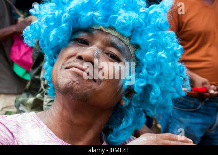 Ein kambodschanischer Mann trägt eine blaue Perücke, während feiert Khmer Neujahr in Chork Dorf, Tboung Provinz, Kambodscha. Stockfoto