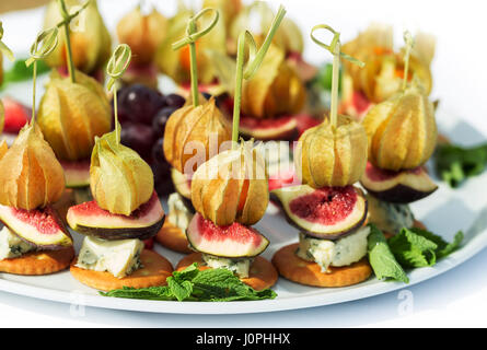 Kanapees mit Physalis, Feigen, Käse und Cracker Stockfoto