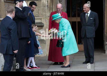 Windsor, UK. 16. April 2017. Vorlegen Sie zwei junge Mädchen, Eowyn Bannan, 6, und Josephine Thompson, 5, die Königin Blumensträuße Blumen, als sie den Ostersonntag Dienst am St. George Chapel in Windsor Castle, begleitet von der Duke of Edinburgh verlässt. Bildnachweis: Mark Kerrison/Alamy Live-Nachrichten Stockfoto