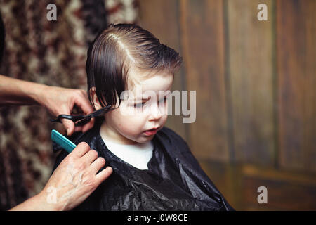 Ein kleiner Junge ist in der Friseur getrimmt Stockfoto