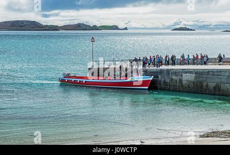 Menschen warten auf das Boot bei höheren Town auf St Martins, Scilly-Inseln an Bord Stockfoto