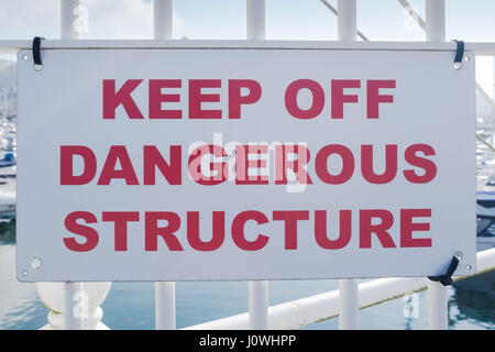 Farbbild der ein Schild mit der Aufschrift zu halten Off gefährliche Struktur in einem Hafen. Stockfoto