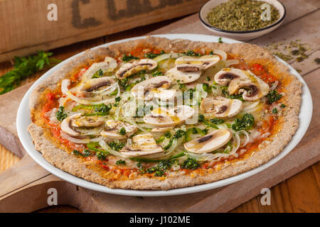 Vollkorn-Pizza mit Tomaten, Käse, Zwiebeln, Champignons und Oregano. Stockfoto