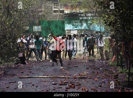 Srinagar, Kaschmir. 17. April 2017. Kashmiri Studenten werfen (unsichtbaren) indische Polizei während einer Protestaktion außerhalb einer Hochschule in Srinagar, Sommer in der Hauptstadt von Kaschmir, 17. April 2017 Ziegeln und Steinen. Dutzende von Menschen, meist Studenten, wurden bei frischen Anti-Indien Proteste und Auseinandersetzungen mit Regierungstruppen in unruhigen Kaschmir am Montag verletzt. Bildnachweis: Javed Dar/Xinhua/Alamy Live-Nachrichten Stockfoto