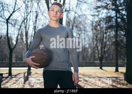 Mann im Park hält Basketball, Minsk, Belarus Stockfoto