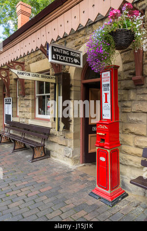 Oldtimer-Bahnsteig-Ticket-Dispenser und Zieltafeln an der Highley Railway auf der Severn Valley Railway, Highley, Shropshire, England, Großbritannien. Stockfoto
