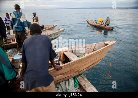 Fischer starten Kanus aus dem Mutter-Boot für das Nachtangeln von Sardinen, lokal bekannt als Buka-Buka, am Tanganjikasee, Sambia Stockfoto