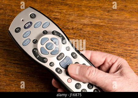 A mans Hand hält eine Sky + HD Fernbedienung Stockfoto