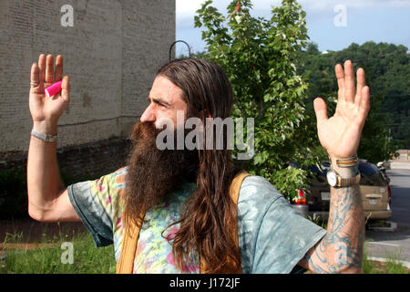 Mann mit langen Haaren und Bart auf der Straße Stockfoto