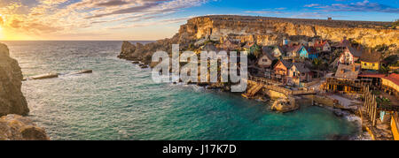 Il-Mellieha, Malta-Sonnenuntergang im berühmten Popeye Village bei Anchor Bay auf ein Panorama-Bild Stockfoto