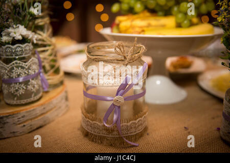 Designer Glas dekoriert mit Band und Seil auf dem Tisch. Handgefertigt für die Hochzeit. Close-up Stockfoto