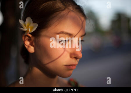 Nachdenklich kaukasischen Frau mit Blume im Haar Stockfoto