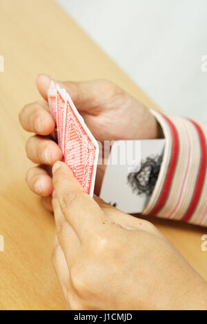 Ein Schuss eines Mannes Betrug beim Karten spielen Stockfoto