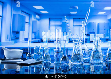 Moderne Laborgeräte, Satz von verschiedenen Glaswaren auf blauem Hintergrund. Stockfoto