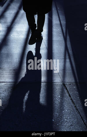 Konzept Hintergrund Mann zu Fuß durch dunkle Gasse in New York City. Blaue Nacht Schatten Reihe. Stockfoto