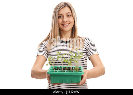 Hübsche Mädchen, das eine Pflanze in einem Topf isoliert auf weißem Hintergrund Stockfoto