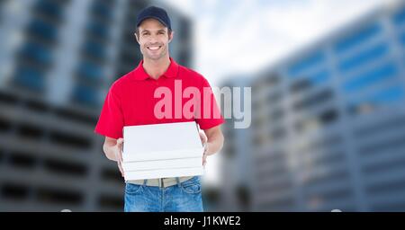 Digital Composite Porträt des Lächelns Pizzamann Pizza-Schachtel an Gebäuden halten Stockfoto
