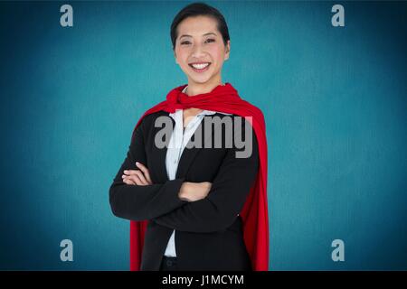 Digital Composite Porträt der Geschäftsfrau trägt Umhang stehend vor blauem Hintergrund Stockfoto