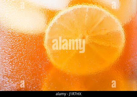 Eistee mit Zitronenscheiben, Wasser Gläser fallen auf Tasse, Kondenswasser. Stockfoto