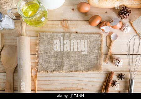 Leere Hanf Sackleinen und Bäckerei Zutaten auf Holztisch Hintergrund mit Textfreiraum, warmen Ton verarbeitet Stockfoto