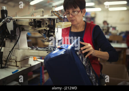 Frau arbeitet in der nähenden Industrie auf Maschine Stockfoto