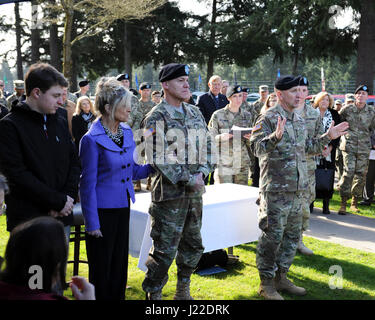 Vor der Korps I Änderung der Befehl Zeremonie kommandierenden General der US Army Forces Command (FORSCOM) General Robert Abrams (rechts) spricht vor der Vergabe die Distinguished Service Medal, das i. Korps Kommandeur Generalleutnant General Stephen Lanza (Mitte), mit seiner Frau Madeline und sein Sohn Raymond Teilnahme an der Zeremonie, 3. April 2017 am Joint Base Lewis-McChord, Washington. (US Armee-Foto von Sidney Lee, Enterprise Multimedia Center, JBLM) Stockfoto