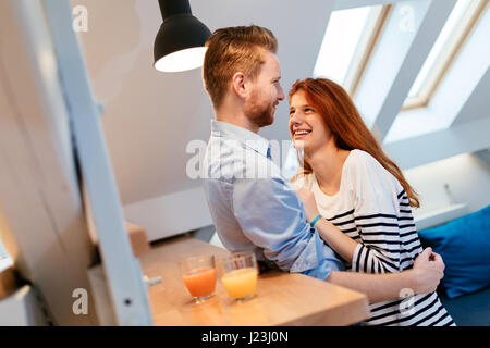 Mann Frau zu Hause und umarmt sie mit Zuneigung Stockfoto