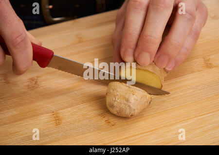 Mannes Hände schneiden frische Tomaten in der Küche eine Mahlzeit zuzubereiten, für das Mittagessen. Topdown-Ansicht. Stockfoto