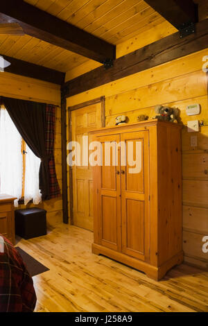 Holz- Kleiderschrank im Schlafzimmer in einem canadiana Landhausstil wohnen gestapelt White Pine log home Stockfoto