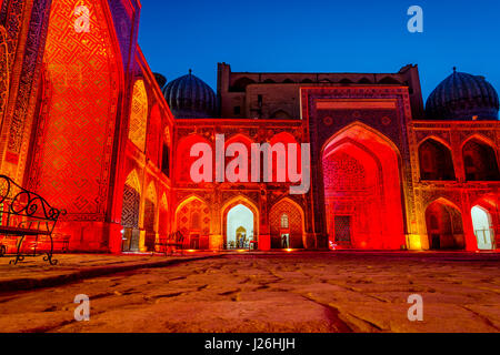 Beleuchtete bunte Atrium des Sher Dor Madrasah bei Nacht, Registan in Samarkand, Usbekistan Stockfoto