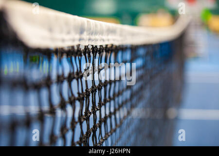 Nahaufnahme des Tennisplatzes durch das Netz Stockfoto